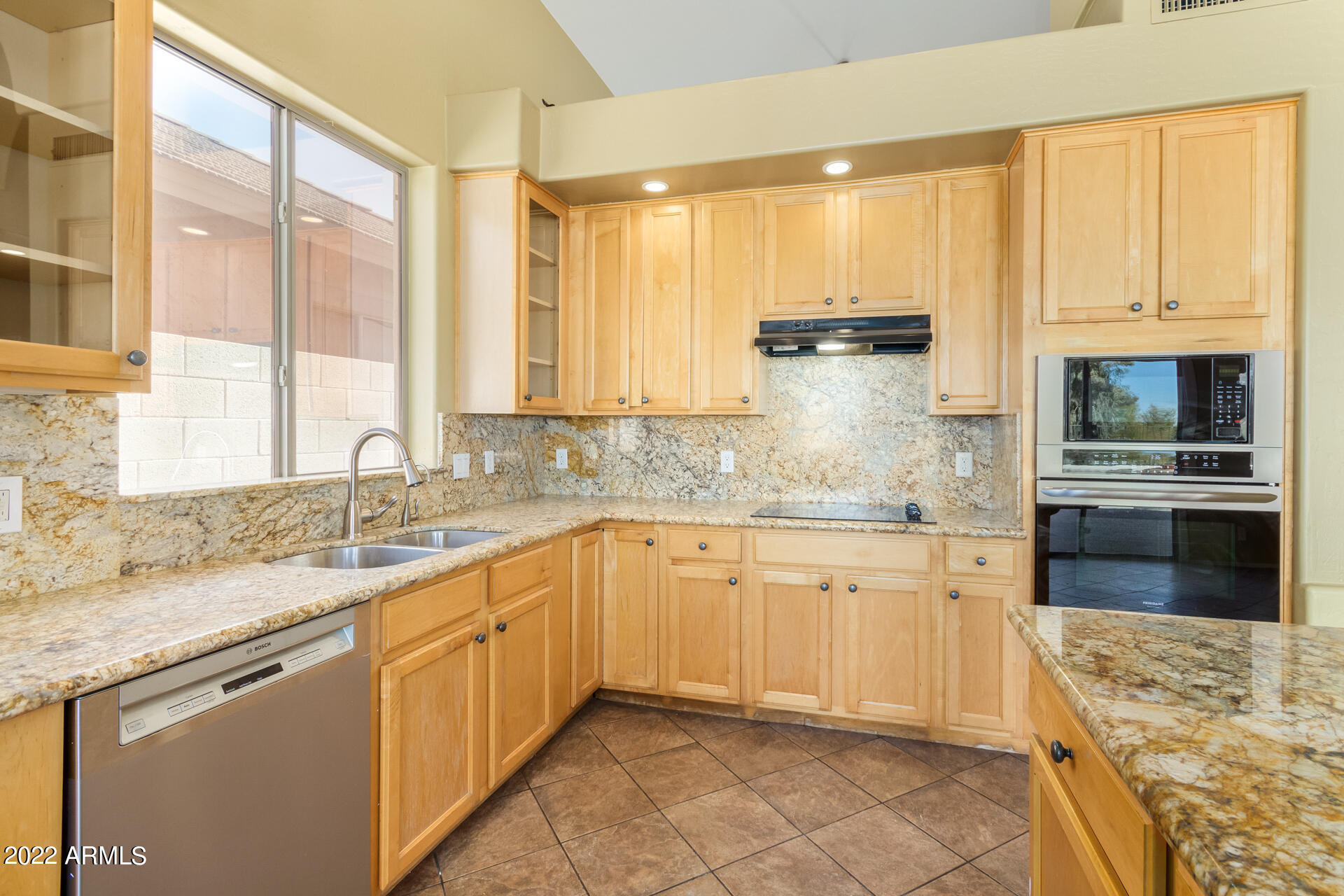 2438 East Fremont Road Phoenix, AZ 85042 - Photo 12 of 45 a kitchen with granite countertop white cabinets and white stainless steel appliances