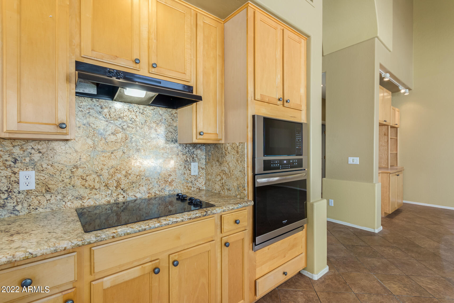 2438 East Fremont Road Phoenix, AZ 85042 - Photo 15 of 45 a kitchen with granite countertop a refrigerator stove and cabinets