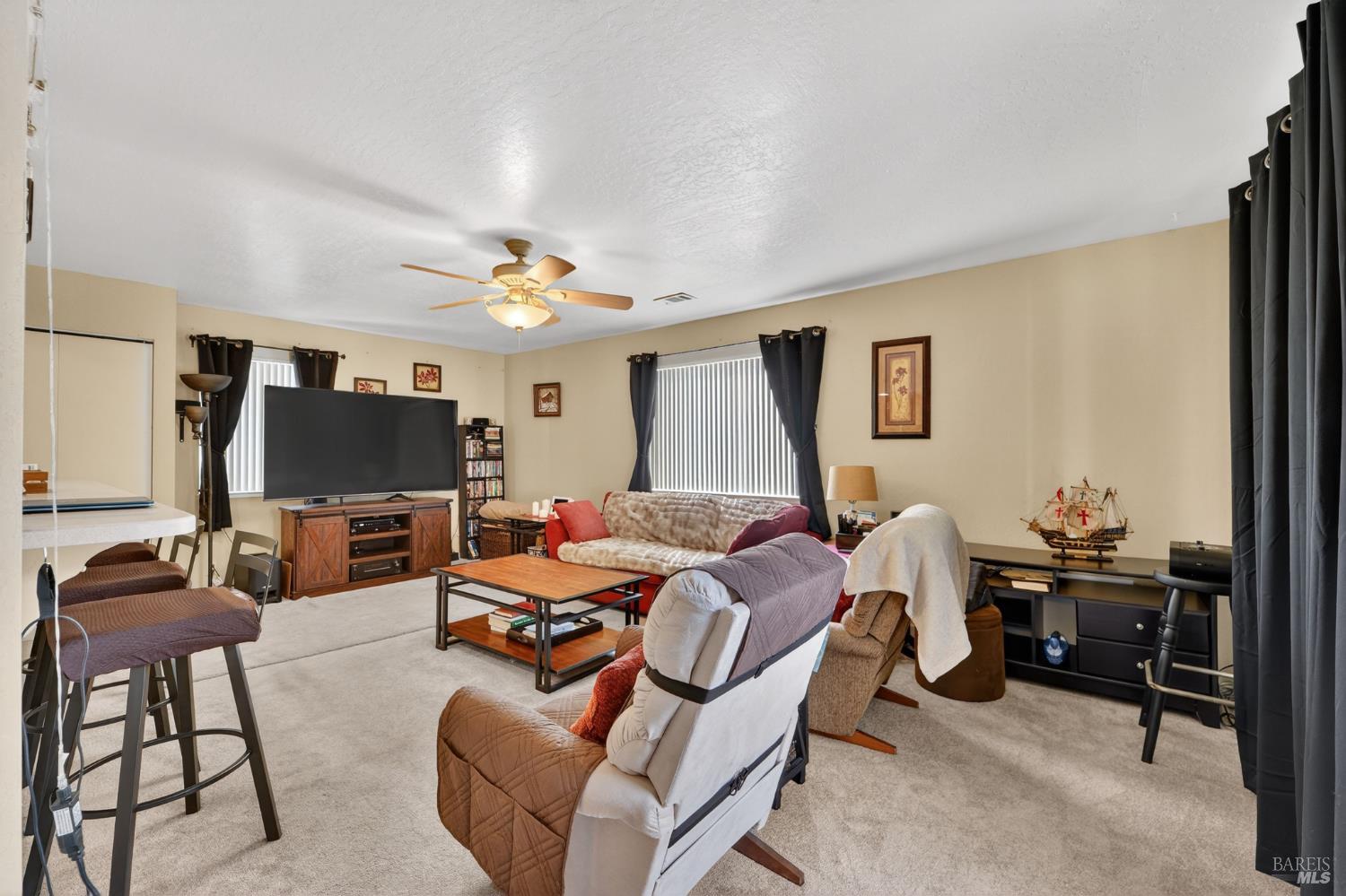 127 Jackson Way Vallejo, CA 94591 - Photo 12 of 35 a living room with furniture a flat screen tv and a window