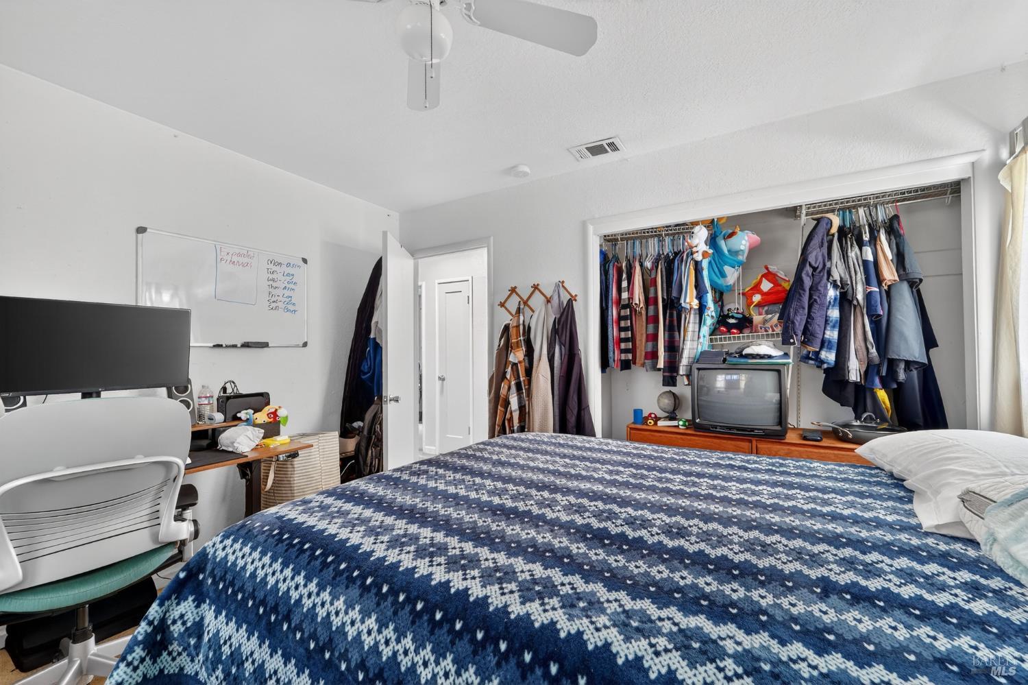 127 Jackson Way Vallejo, CA 94591 - Photo 22 of 35 a bedroom with a bed and a walk in closet