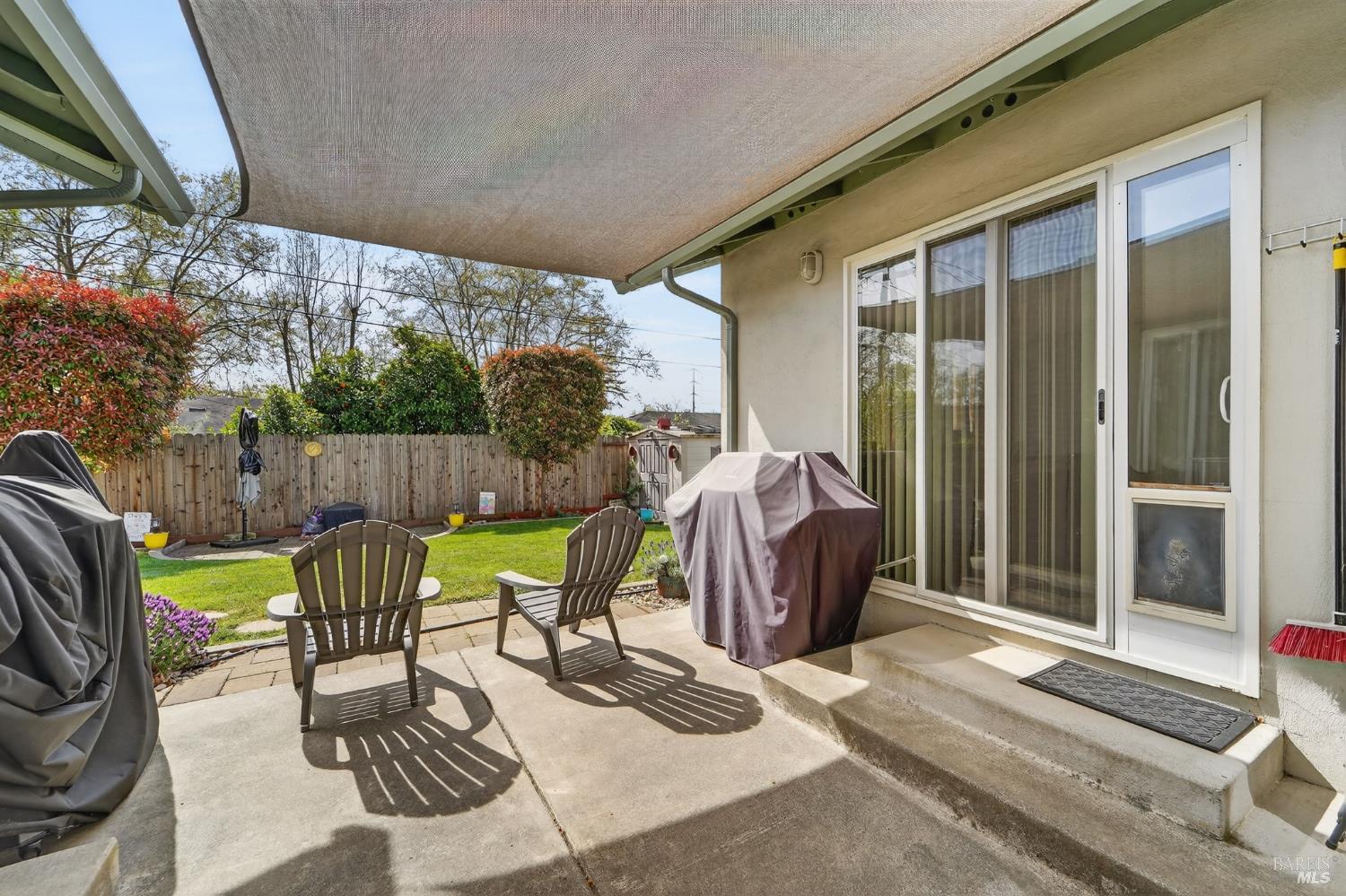 127 Jackson Way Vallejo, CA 94591 - Photo 28 of 35 a view of a patio with table and chairs potted plants with floor to ceiling window and tree