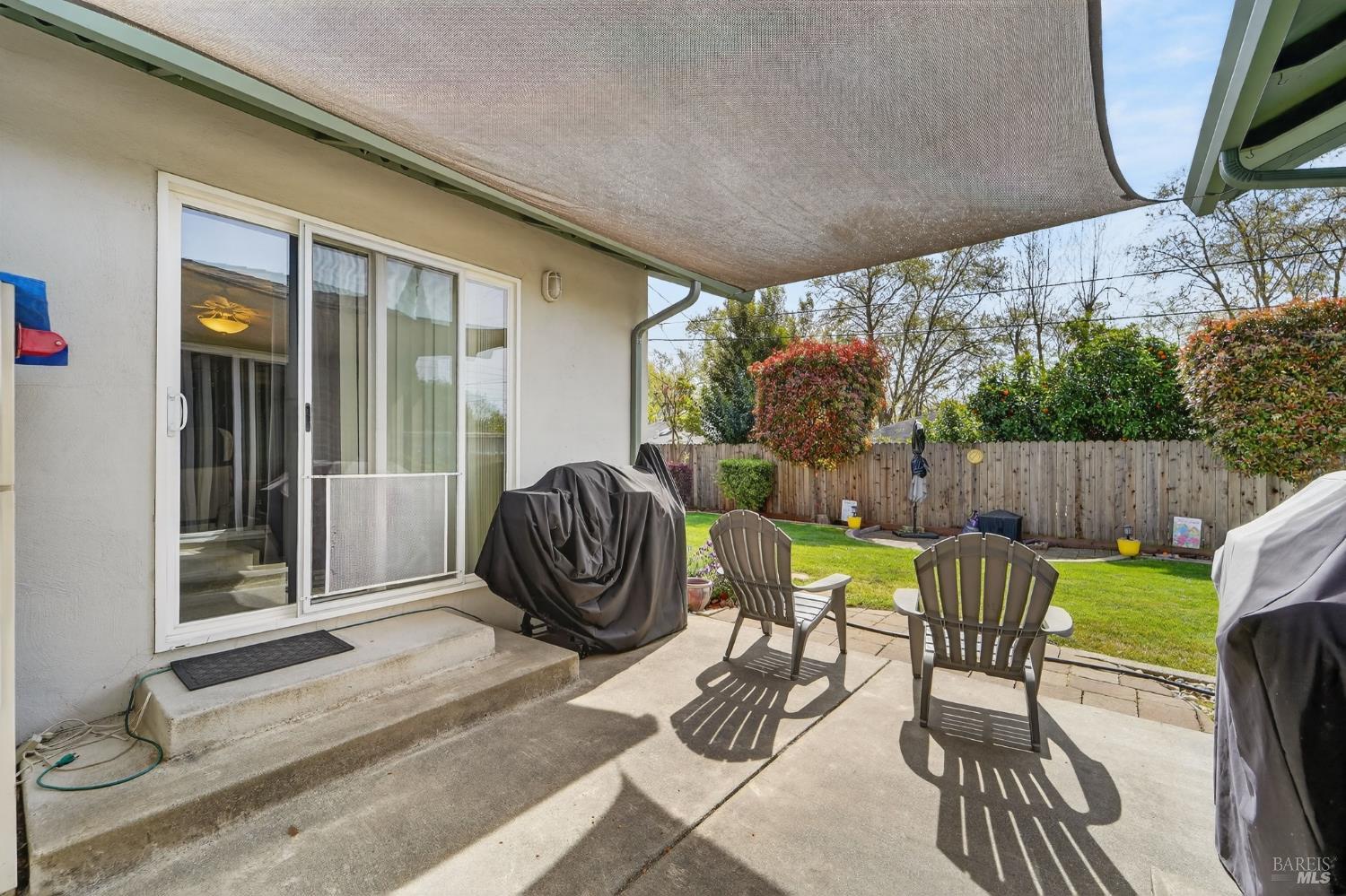 127 Jackson Way Vallejo, CA 94591 - Photo 29 of 35 a view of a patio with table and chairs potted plants and floor to ceiling window