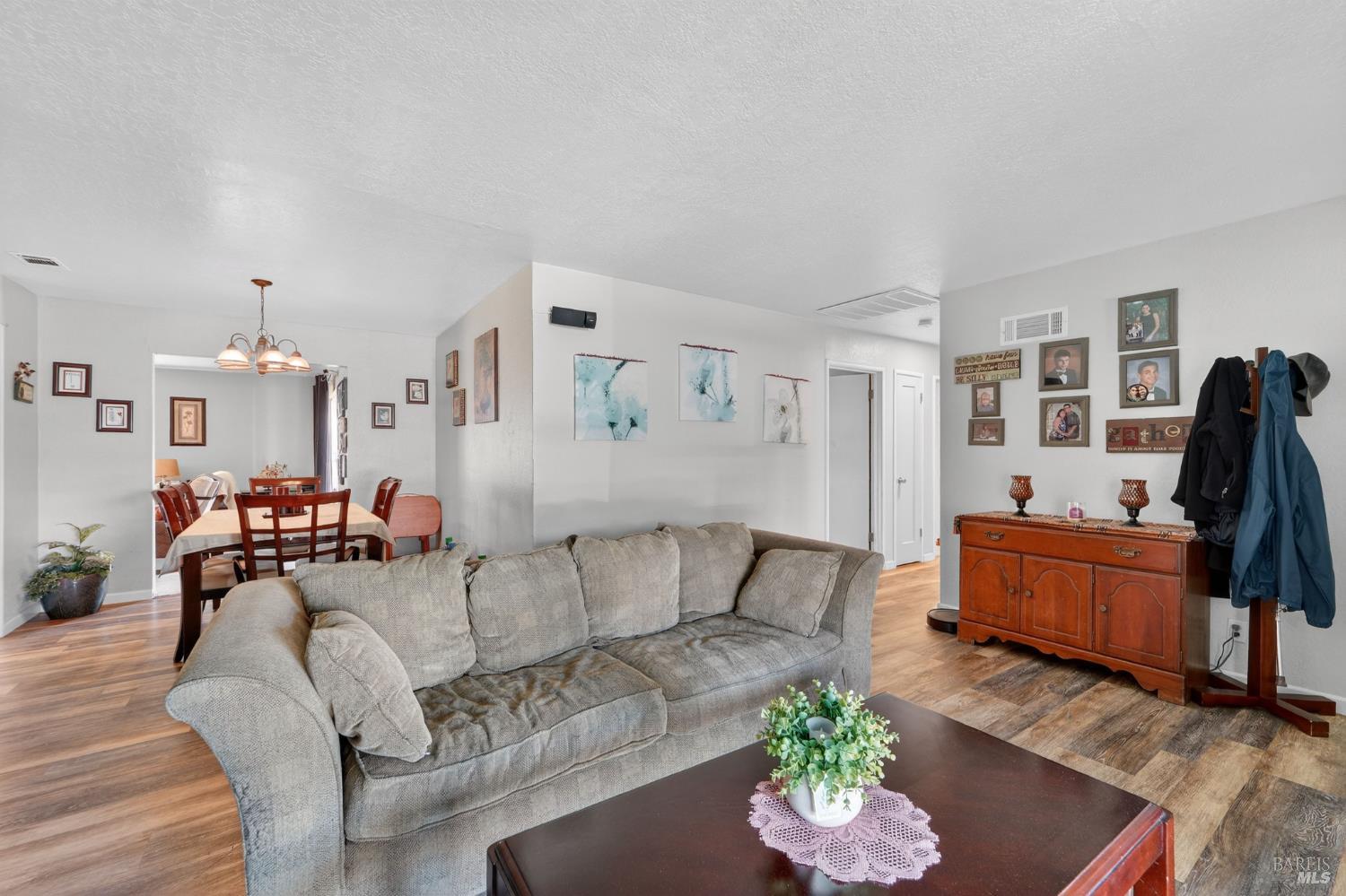 127 Jackson Way Vallejo, CA 94591 - Photo 7 of 35 a living room with furniture and a dining table with wooden floor