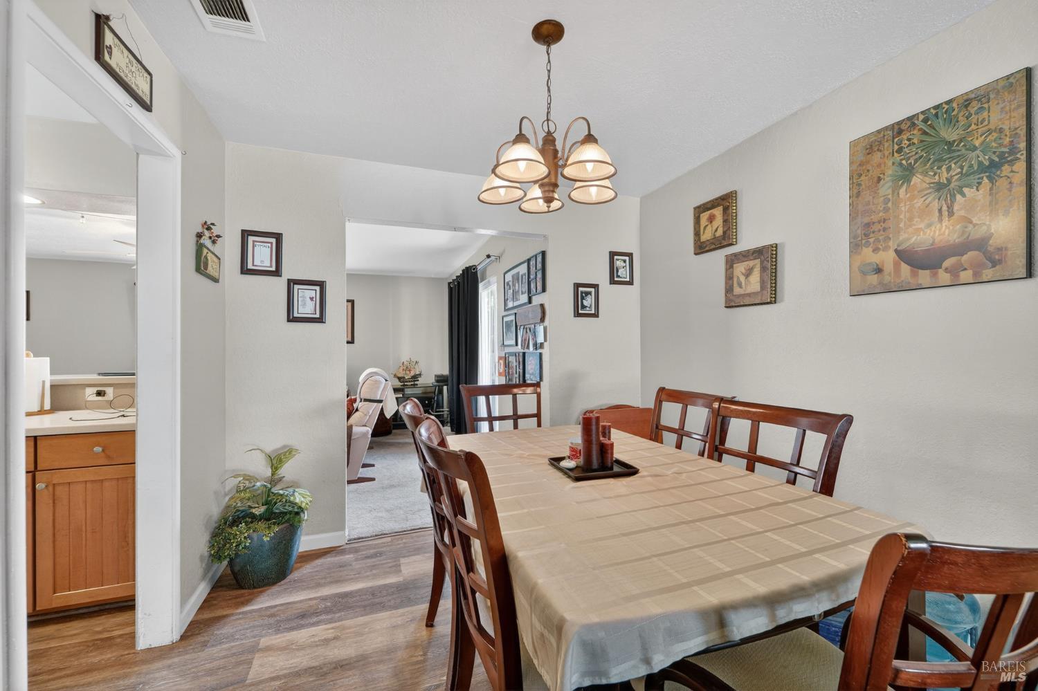 127 Jackson Way Vallejo, CA 94591 - Photo 9 of 35 a view of a dining room with furniture wooden floor and a chandelier