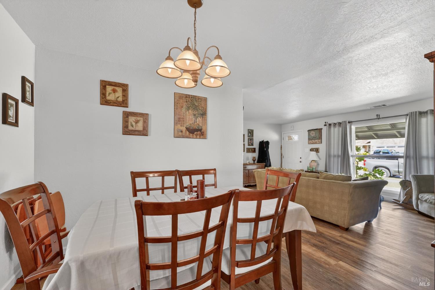 127 Jackson Way Vallejo, CA 94591 - Photo 10 of 35 a view of a dining room with furniture wooden floor and chandelier