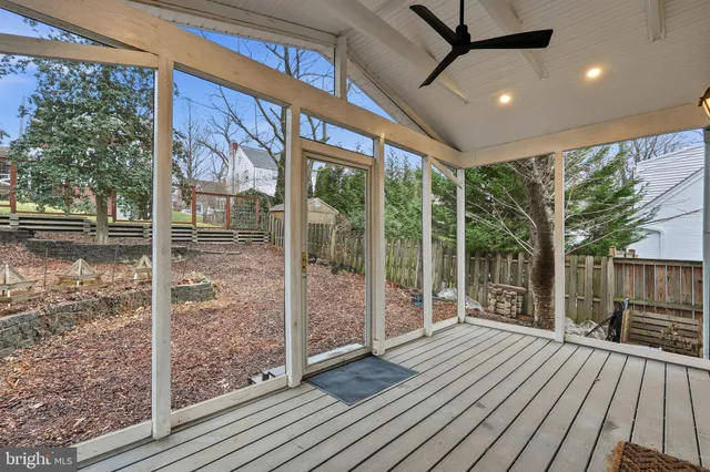 a porch with wooden floor in front of a house
