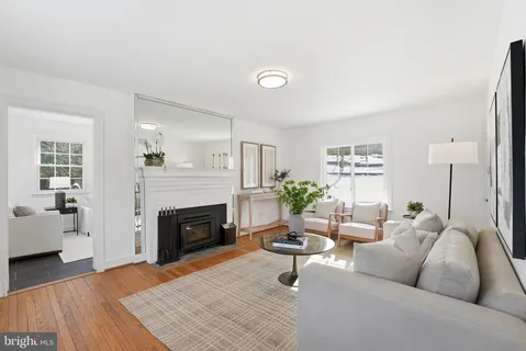 a living room with furniture a fireplace and a table