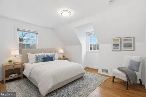 a bedroom with a bed and a chair