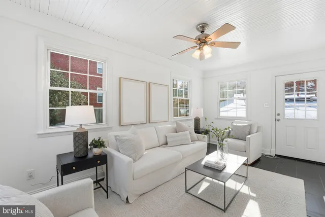 a living room with furniture a window and a chandelier