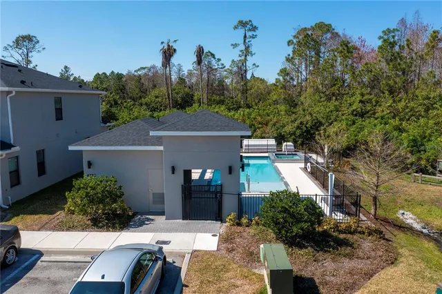 a view of a patio with table and chairs potted plants and a large tree