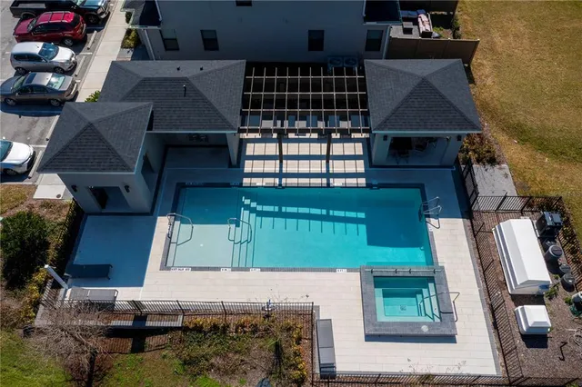 an aerial view of residential houses with outdoor space
