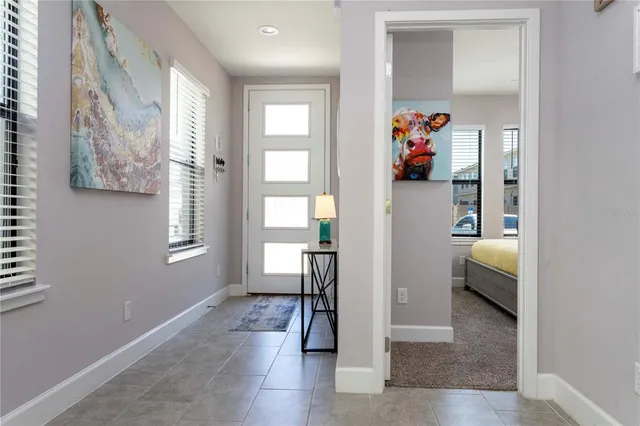 a bedroom with a bed and a lamp on dresser