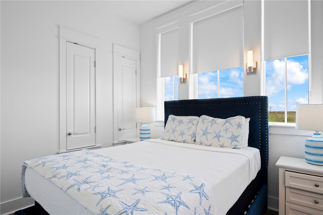 214 Sunset Avenue, Unit 2 Port Aransas, TX 78373 - Photo 11 of 37 a bedroom with a bed and a window