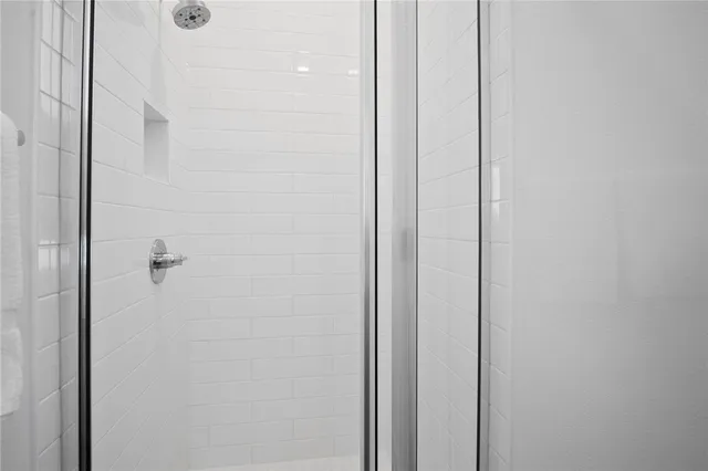 a bathroom with a sink a mirror and a shower