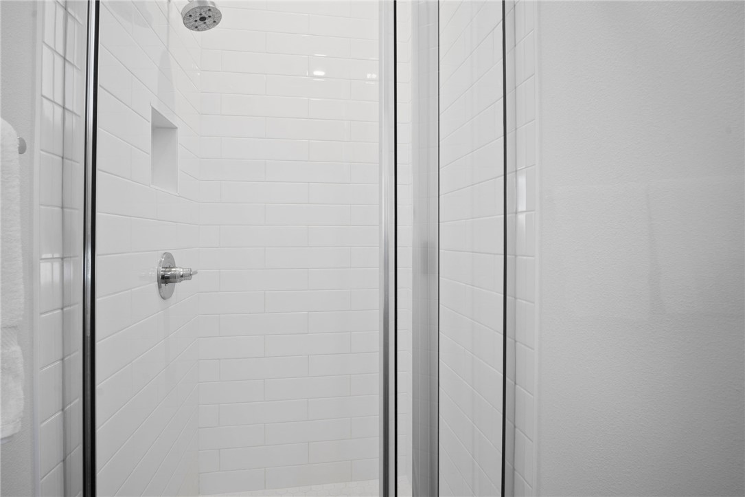 214 Sunset Avenue, Unit 2 Port Aransas, TX 78373 - Photo 12 of 37 a bathroom with a shower