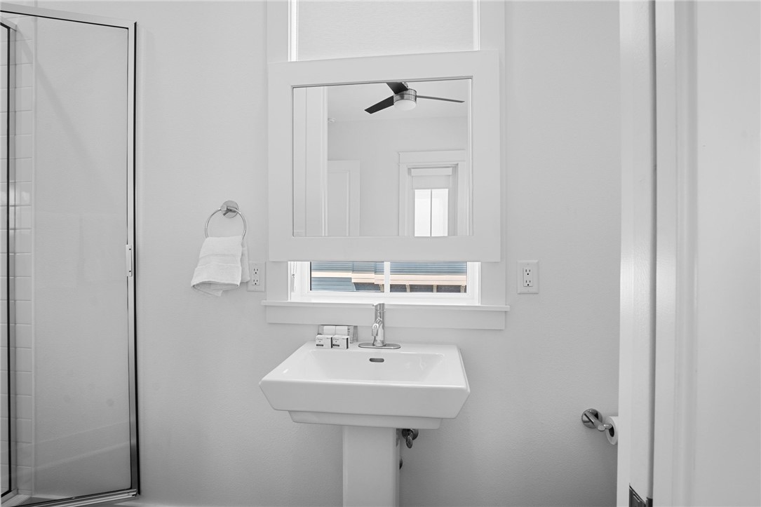 214 Sunset Avenue, Unit 2 Port Aransas, TX 78373 - Photo 16 of 37 a bathroom with a sink and a mirror