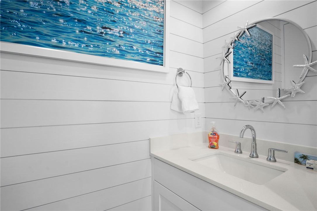 214 Sunset Avenue, Unit 2 Port Aransas, TX 78373 - Photo 18 of 37 a bathroom with a sink and vanity