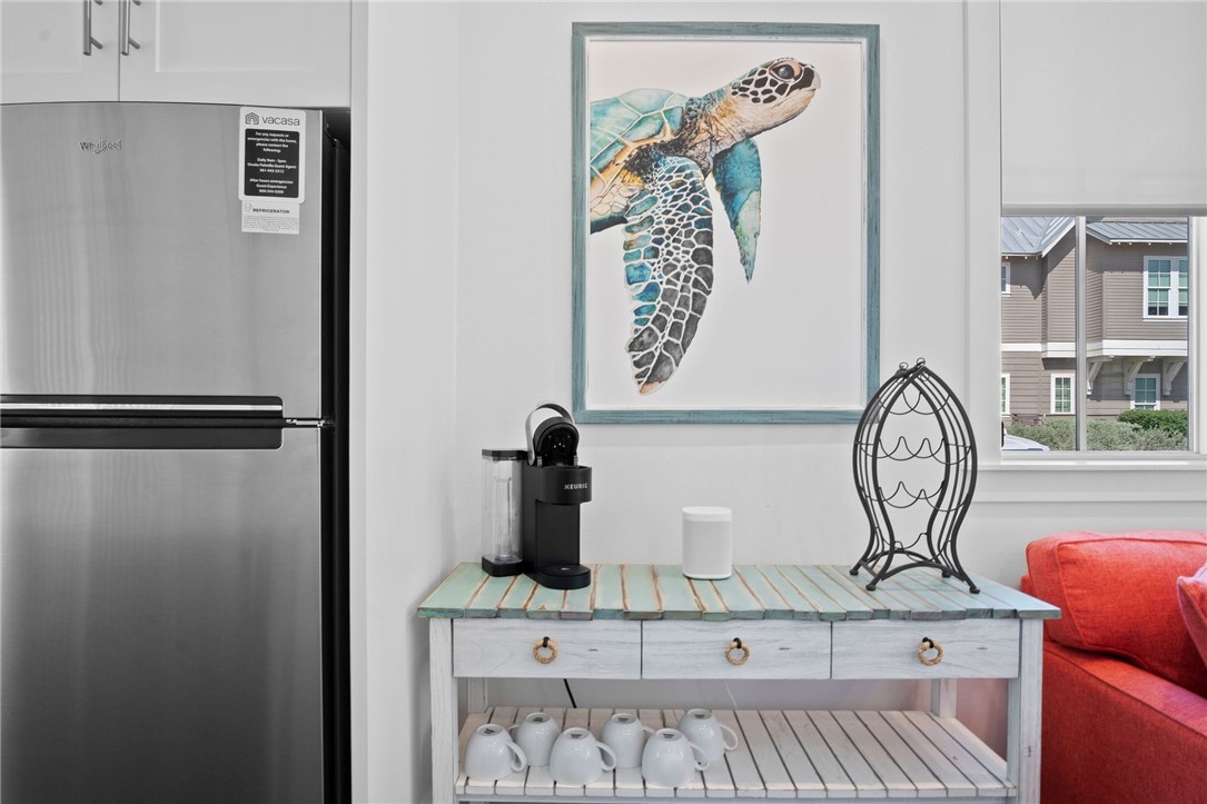 214 Sunset Avenue, Unit 2 Port Aransas, TX 78373 - Photo 7 of 37 a view of a door and chair in a kitchen