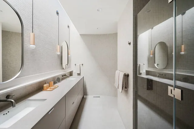 a view of a bedroom with wooden floor and white walls
