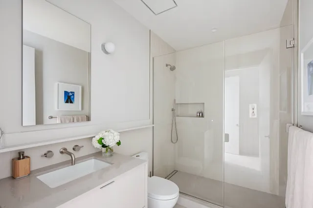 a bedroom with a bed and a mirror