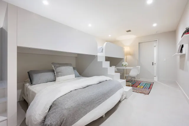 a view of a patio with chairs and a table under an umbrella