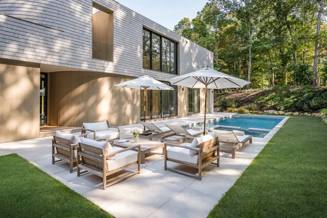 a front view of a house with a yard table and chairs