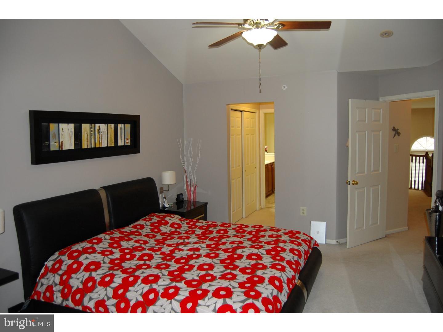 28 Madison Way Downingtown, PA 19335 - Photo 11 of 44 a bedroom with a bed and a chandelier