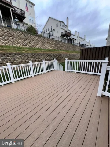 a view of balcony with hardwood floor and lake view