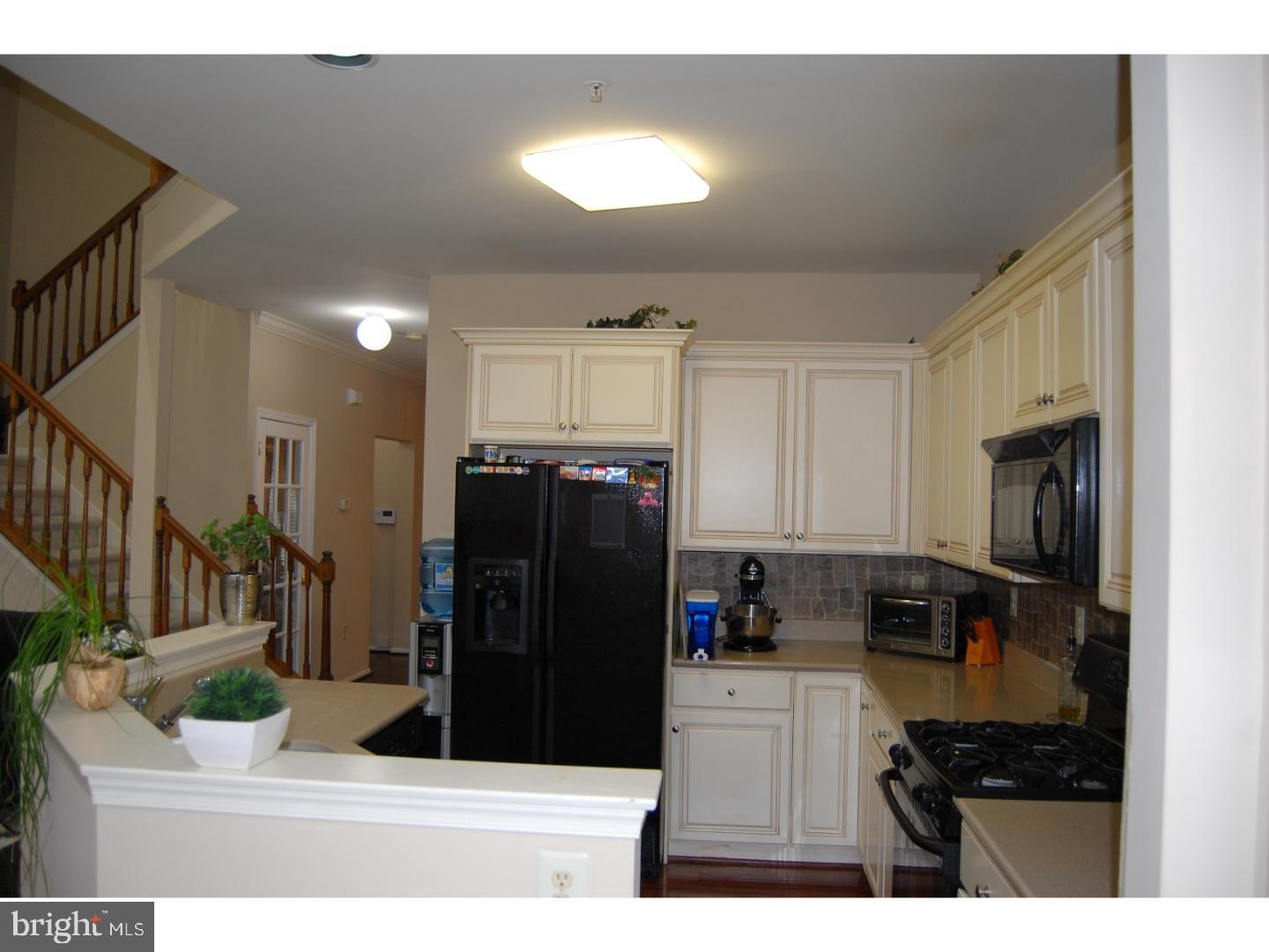 28 Madison Way Downingtown, PA 19335 - Photo 8 of 44 a kitchen with refrigerator and cabinets