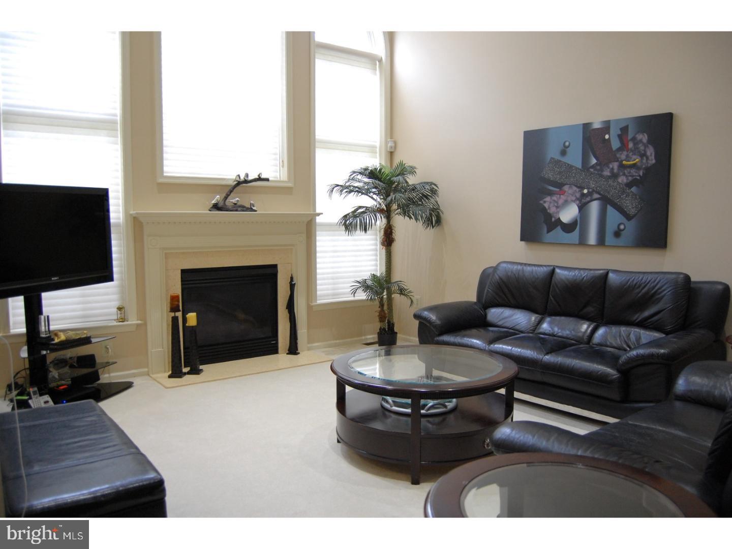 28 Madison Way Downingtown, PA 19335 - Photo 9 of 44 a living room with furniture a fireplace and a flat screen tv