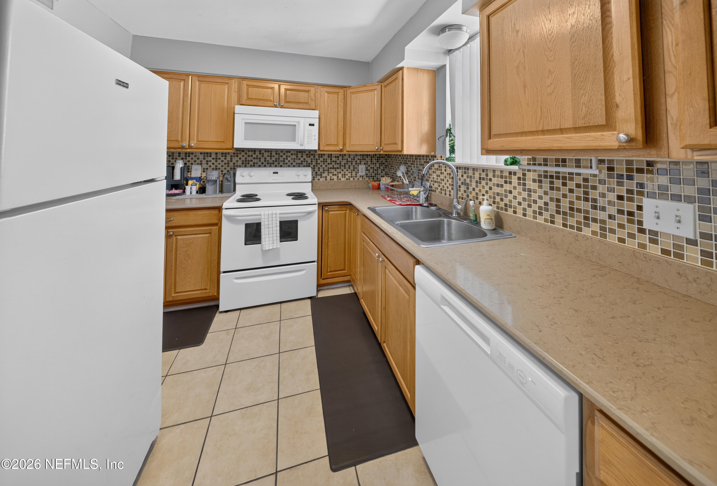 7346 El Barco Road, Unit 4 Jacksonville, FL 32216 - Photo 4 of 19 a kitchen with a sink a stove and cabinets