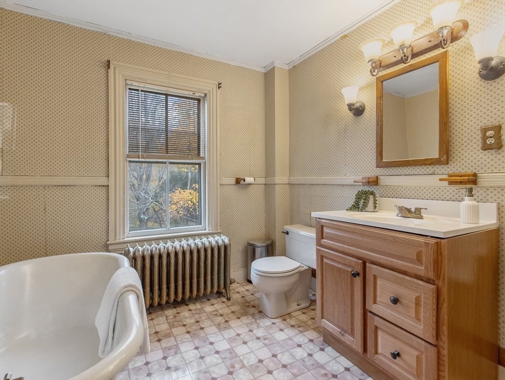12 Spring Street Foxboro, MA 02035 - Photo 28 of 42 a bathroom with a sink a toilet a mirror and bathtub