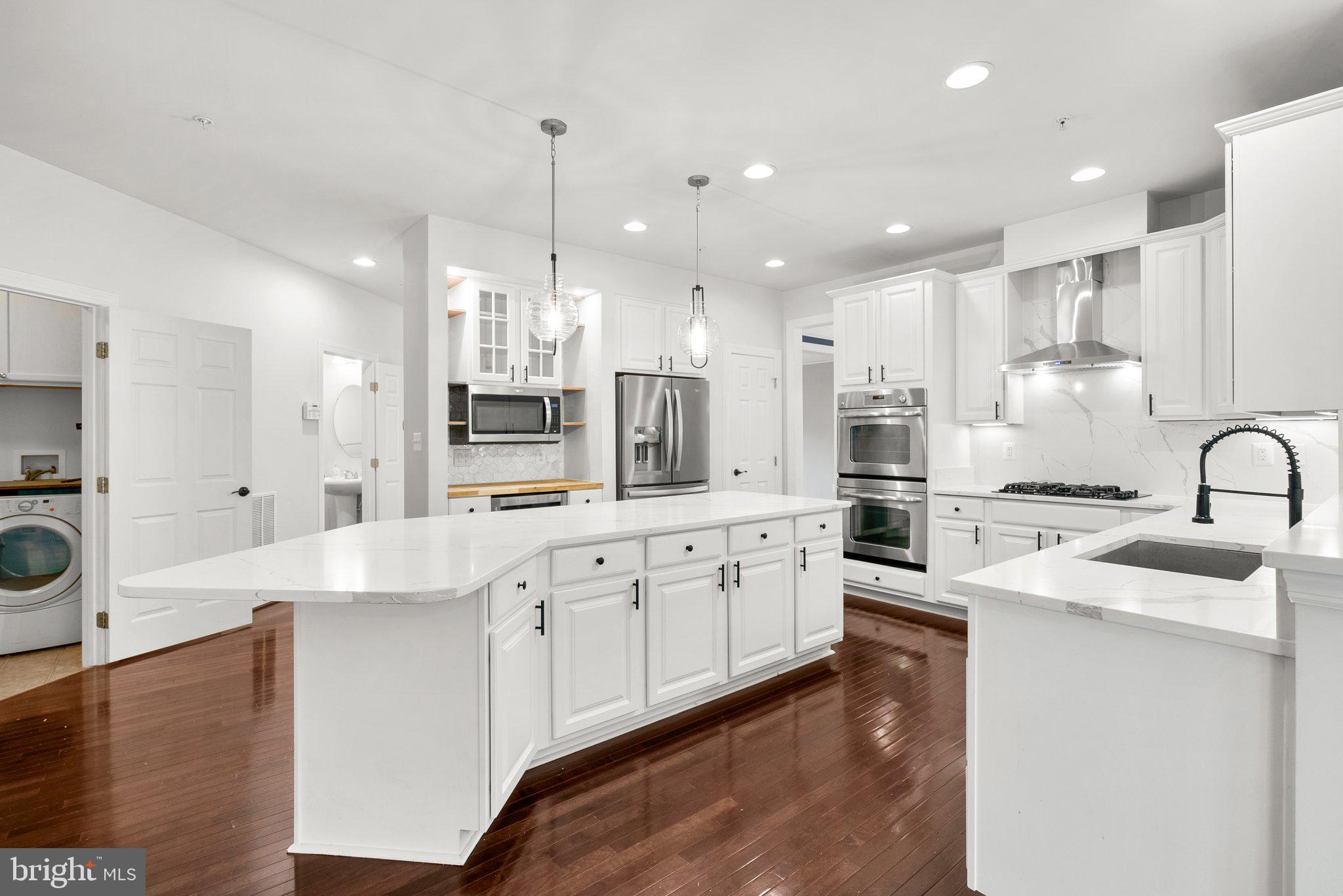 8304 Cedarview Court Clinton, MD 20735 - Photo 11 of 39 a large kitchen with granite countertop a sink a counter top stainless steel appliances and cabinets