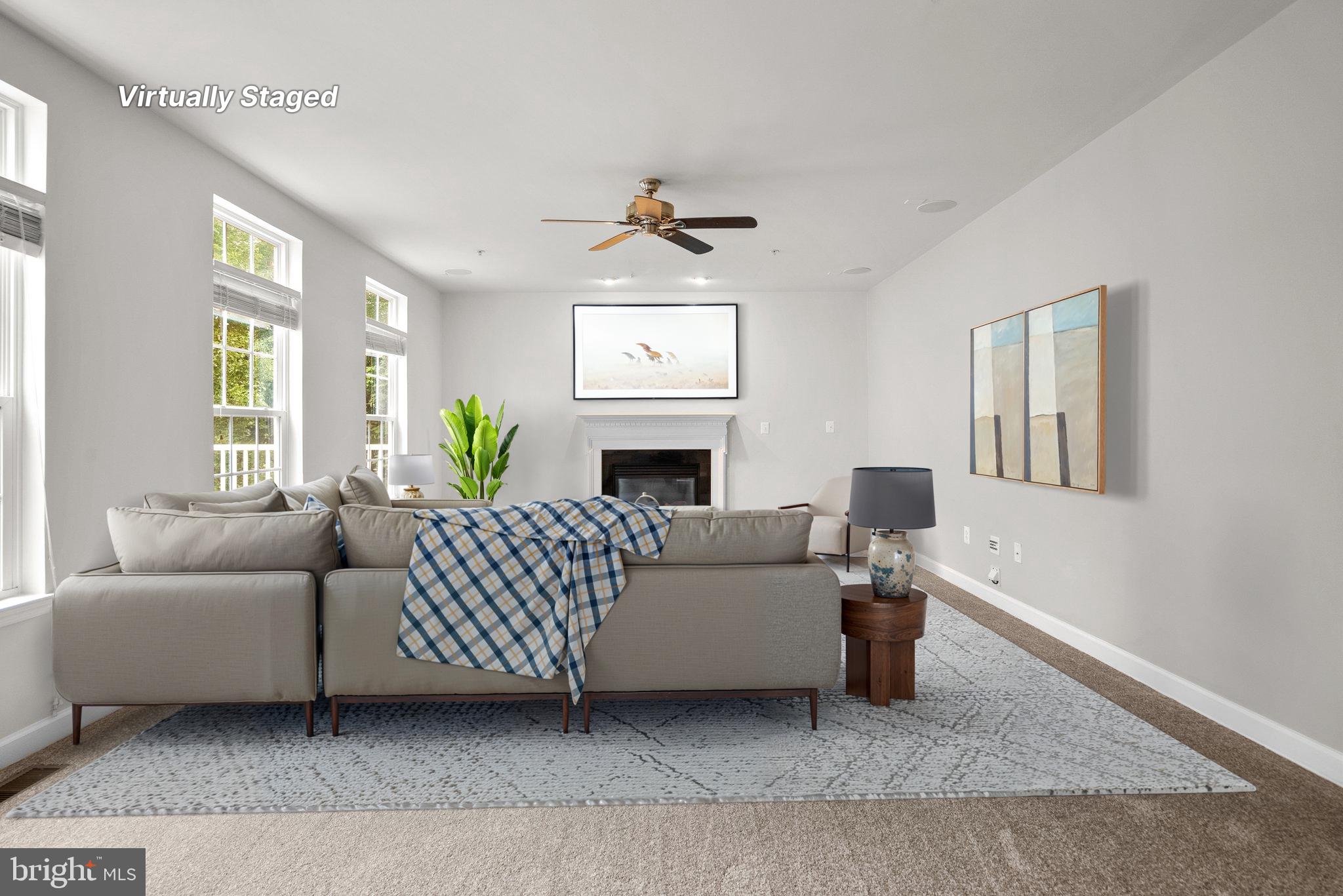 8304 Cedarview Court Clinton, MD 20735 - Photo 16 of 39 a living room with furniture a fireplace and a window