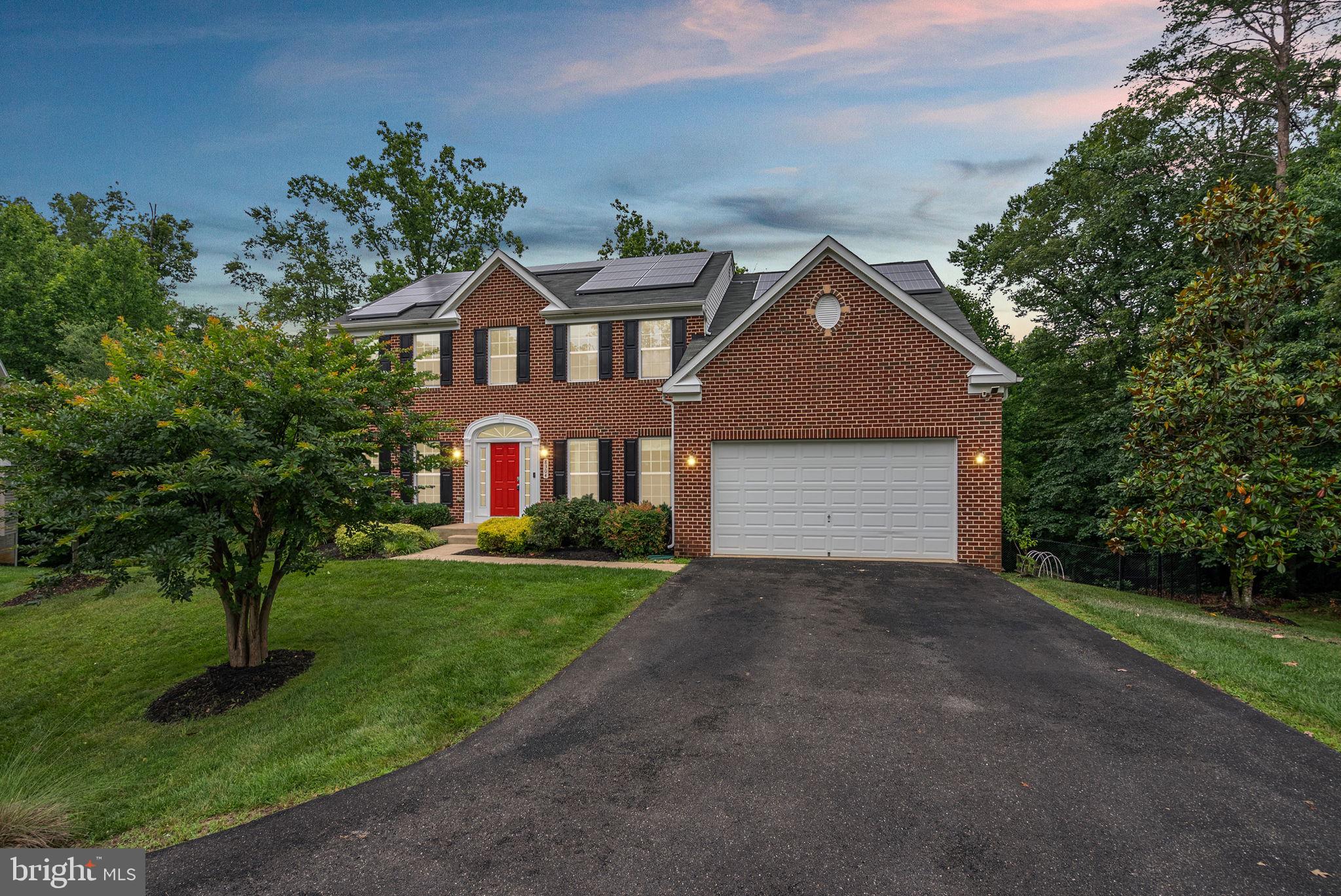 8304 Cedarview Court Clinton, MD 20735 - Photo 2 of 39 a front view of a house with a yard and garage