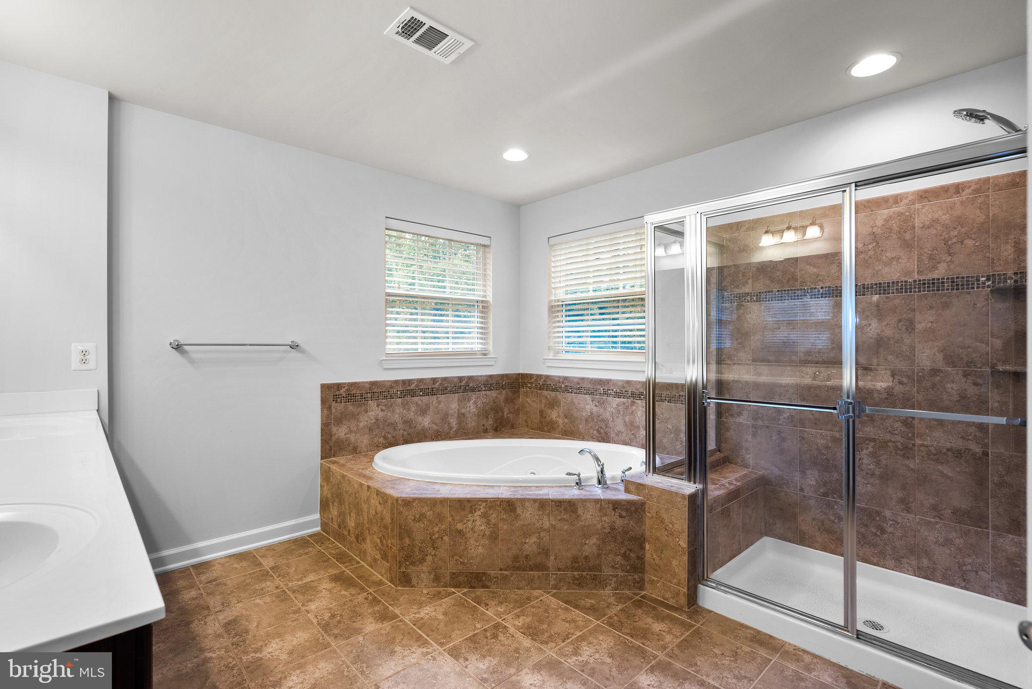 8304 Cedarview Court Clinton, MD 20735 - Photo 21 of 39 a bathroom with a tub and window