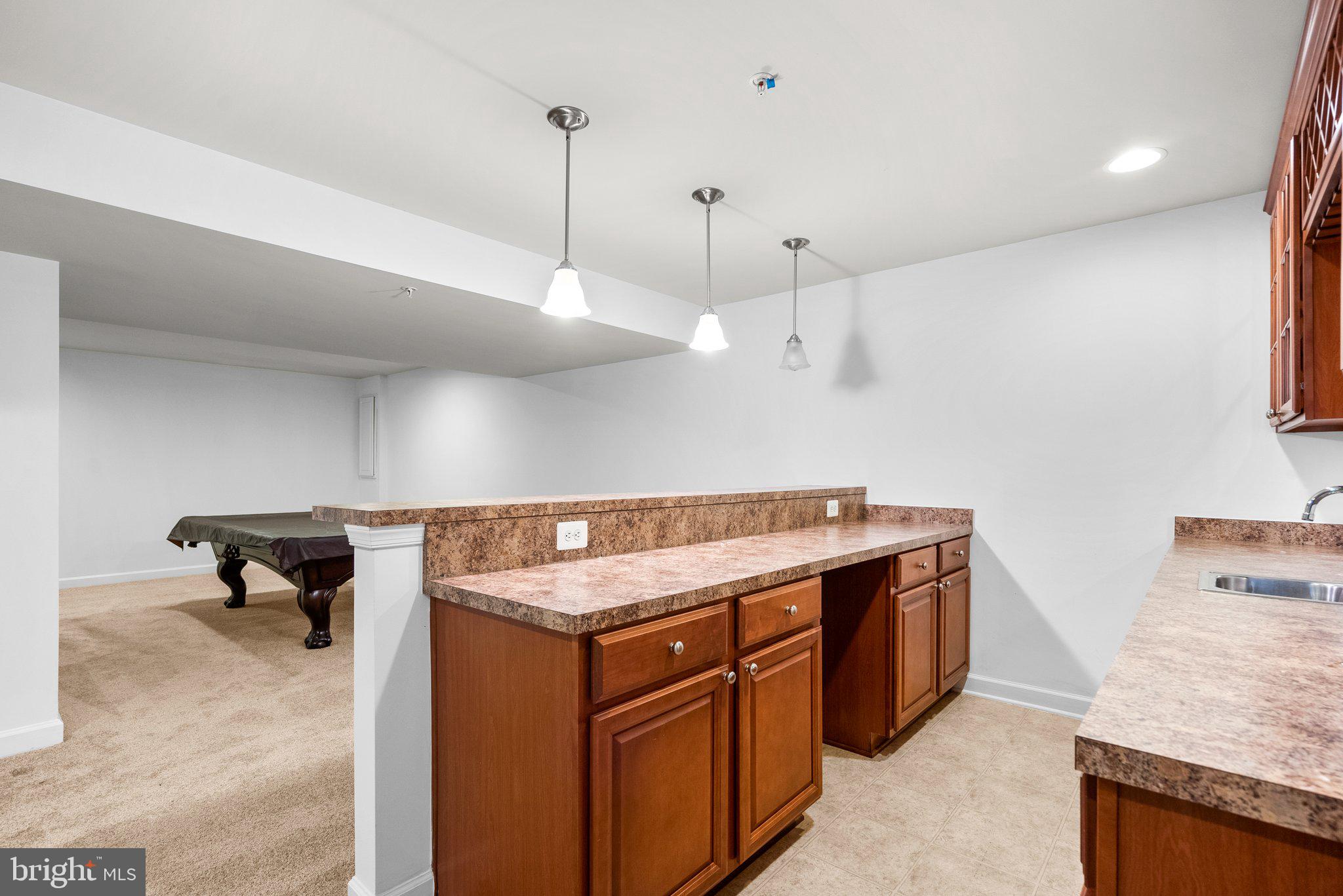 8304 Cedarview Court Clinton, MD 20735 - Photo 29 of 39 a kitchen with a stove a sink and a wooden floor