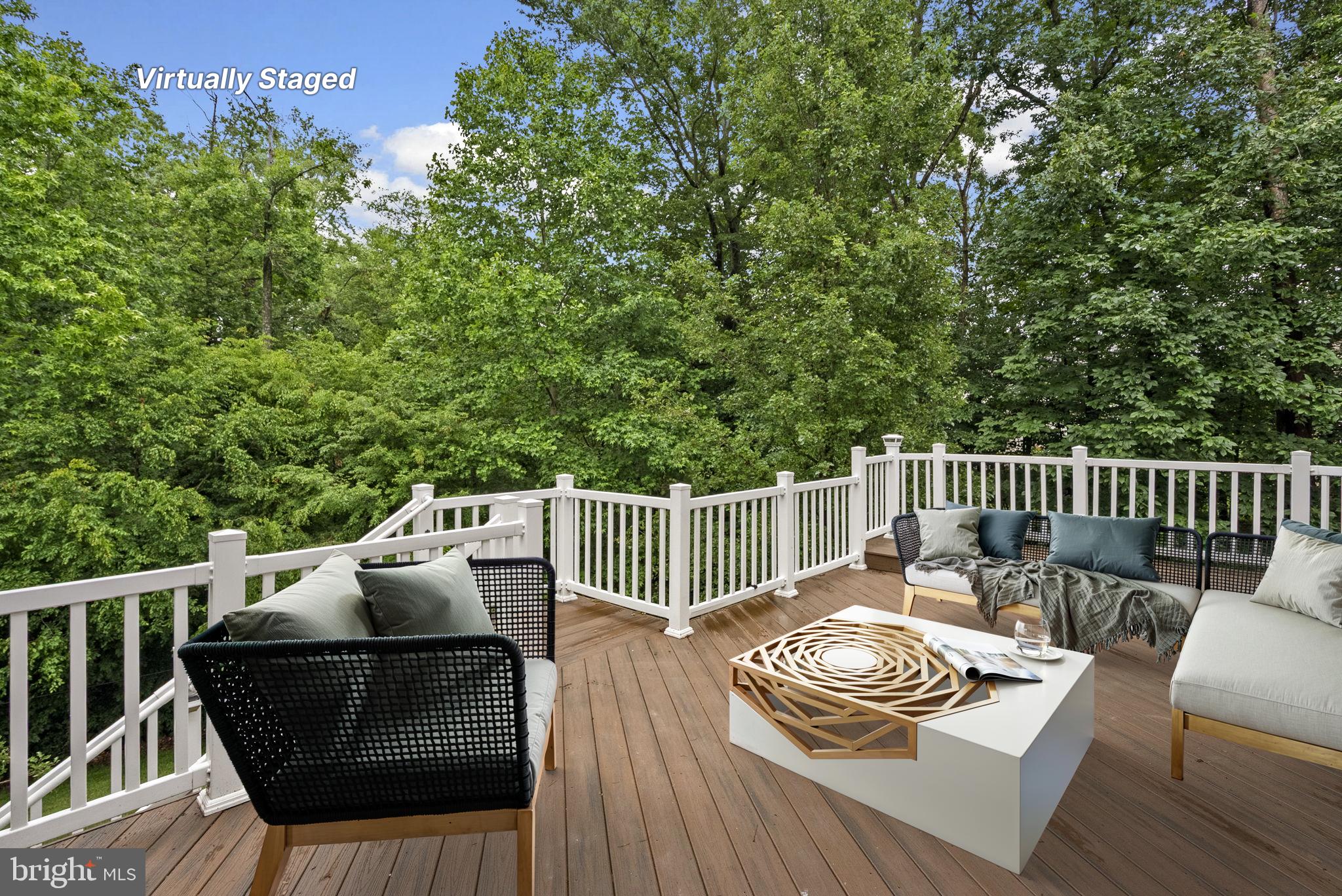 8304 Cedarview Court Clinton, MD 20735 - Photo 36 of 39 a view of a deck with a table and chairs with wooden floor