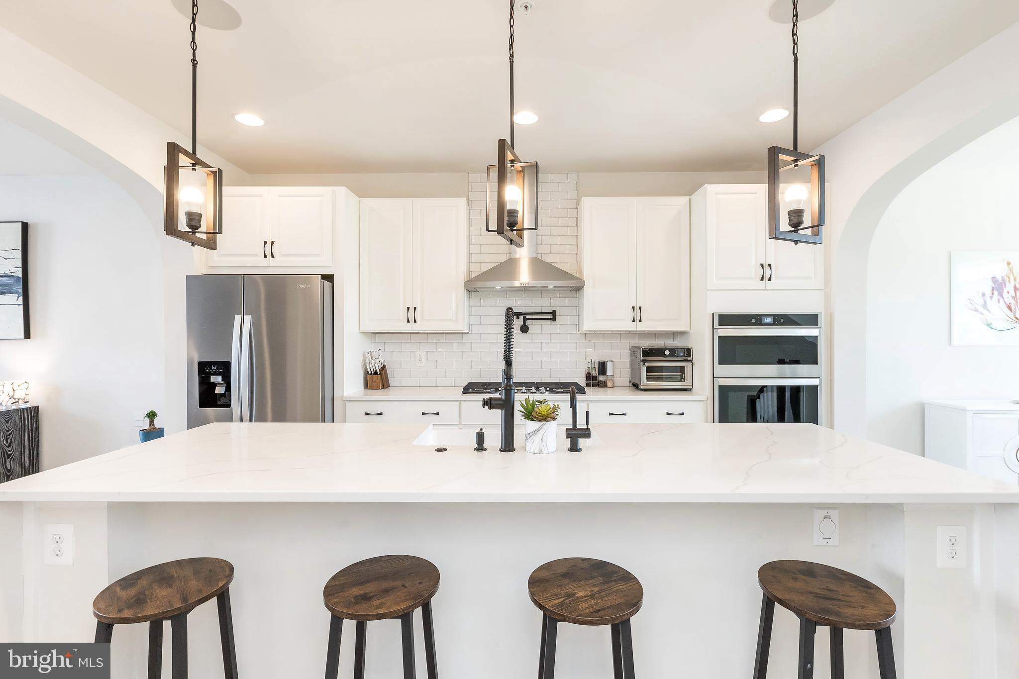 1096 Holden Road Frederick, MD 21701 - Photo 1 of 51 a kitchen with cabinets and chairs