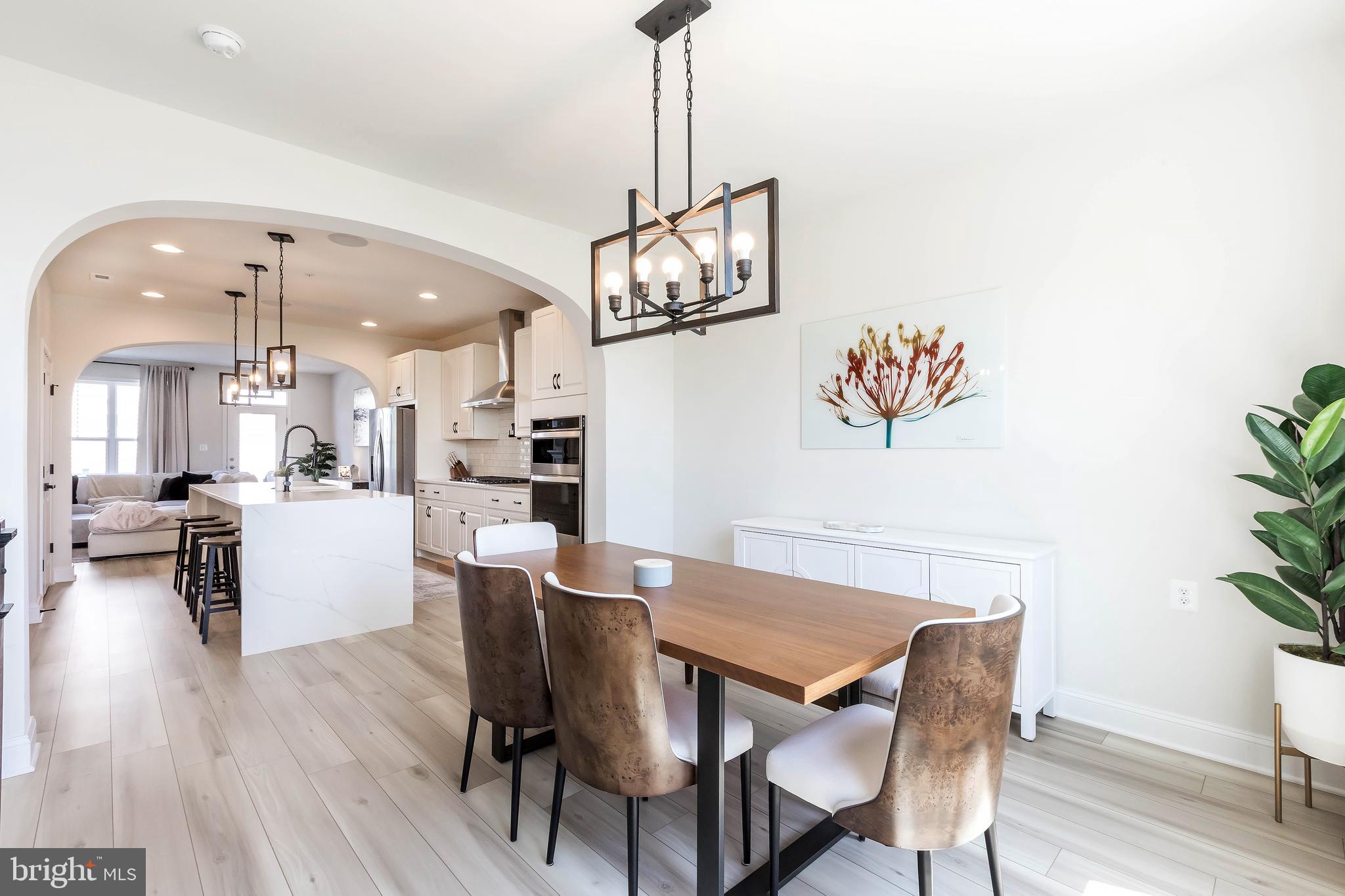 1096 Holden Road Frederick, MD 21701 - Photo 11 of 51 a view of a dining room with furniture wooden floor and chandelier