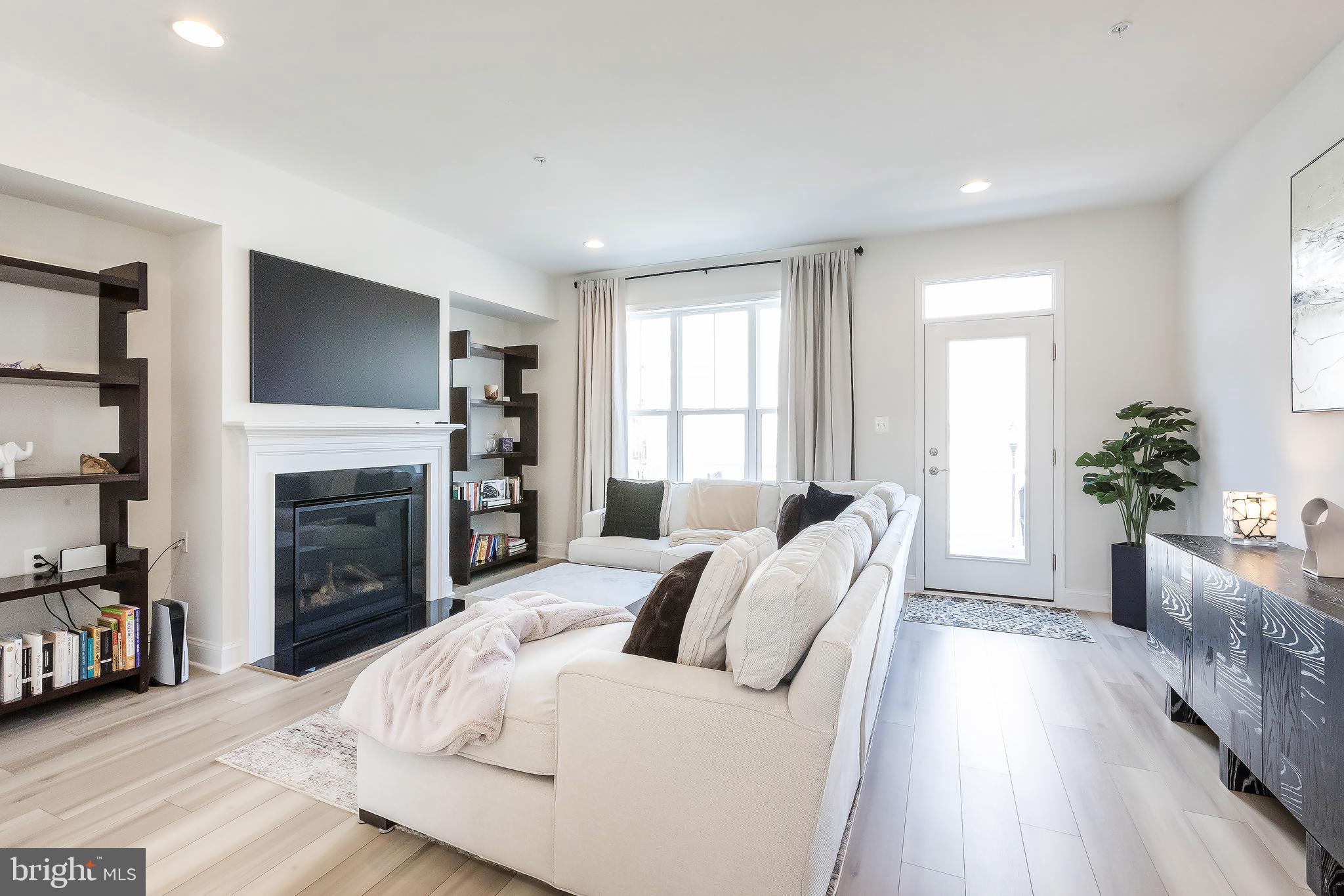 1096 Holden Road Frederick, MD 21701 - Photo 13 of 51 a living room with furniture a fireplace and a flat screen tv