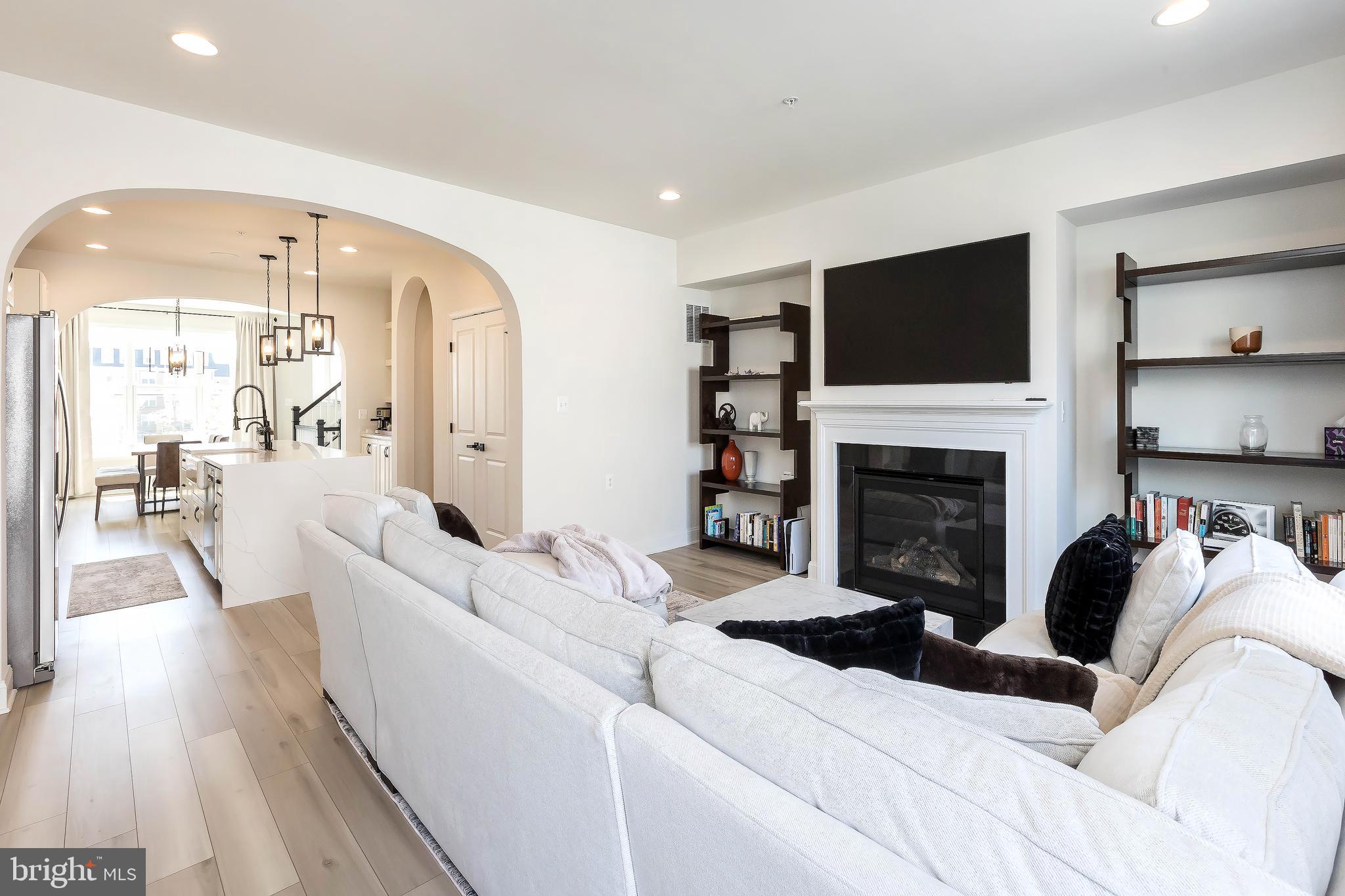1096 Holden Road Frederick, MD 21701 - Photo 16 of 51 a living room with furniture a flat screen tv and a fireplace