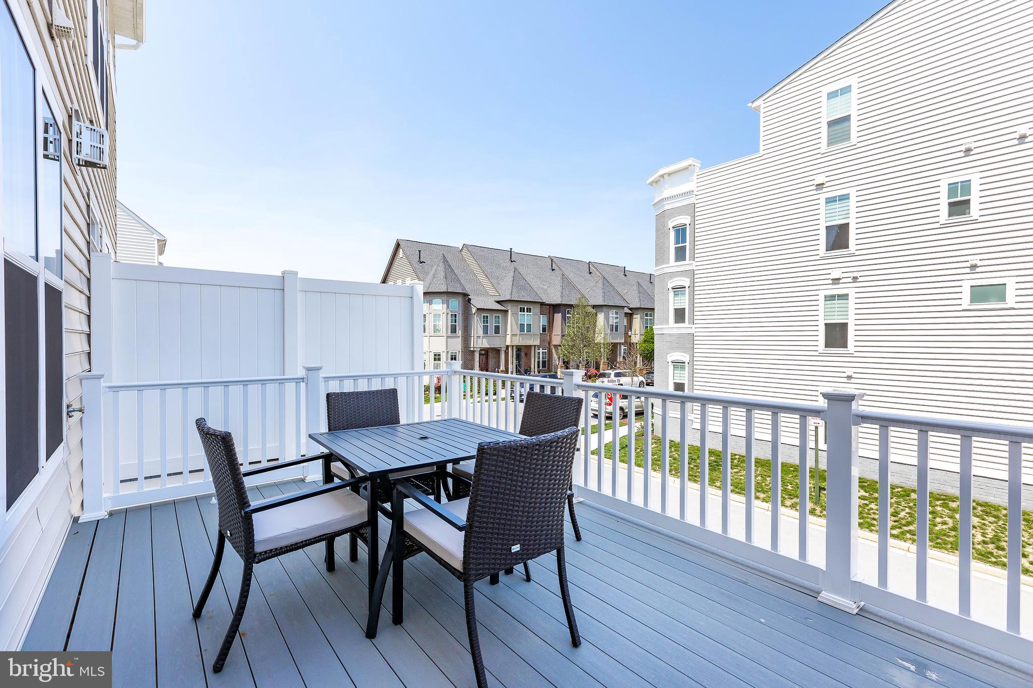 1096 Holden Road Frederick, MD 21701 - Photo 17 of 51 a view of a deck with table and chairs with wooden floor and fence