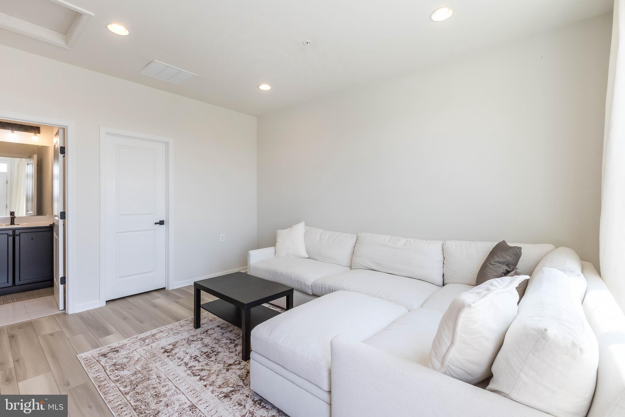 1096 Holden Road Frederick, MD 21701 - Photo 33 of 51 a living room with furniture and wooden floor