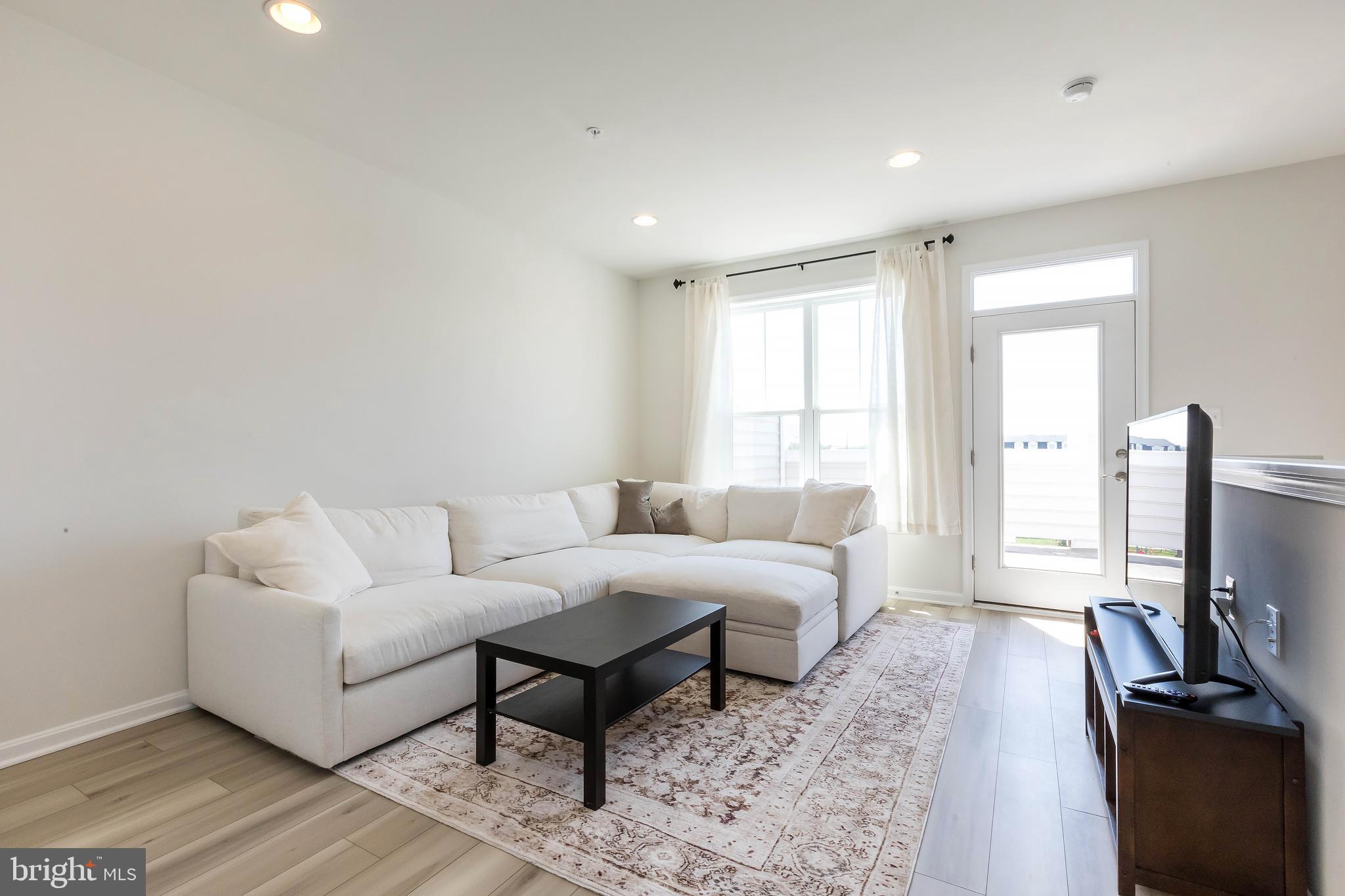 1096 Holden Road Frederick, MD 21701 - Photo 34 of 51 a living room with furniture a flat screen tv and a window