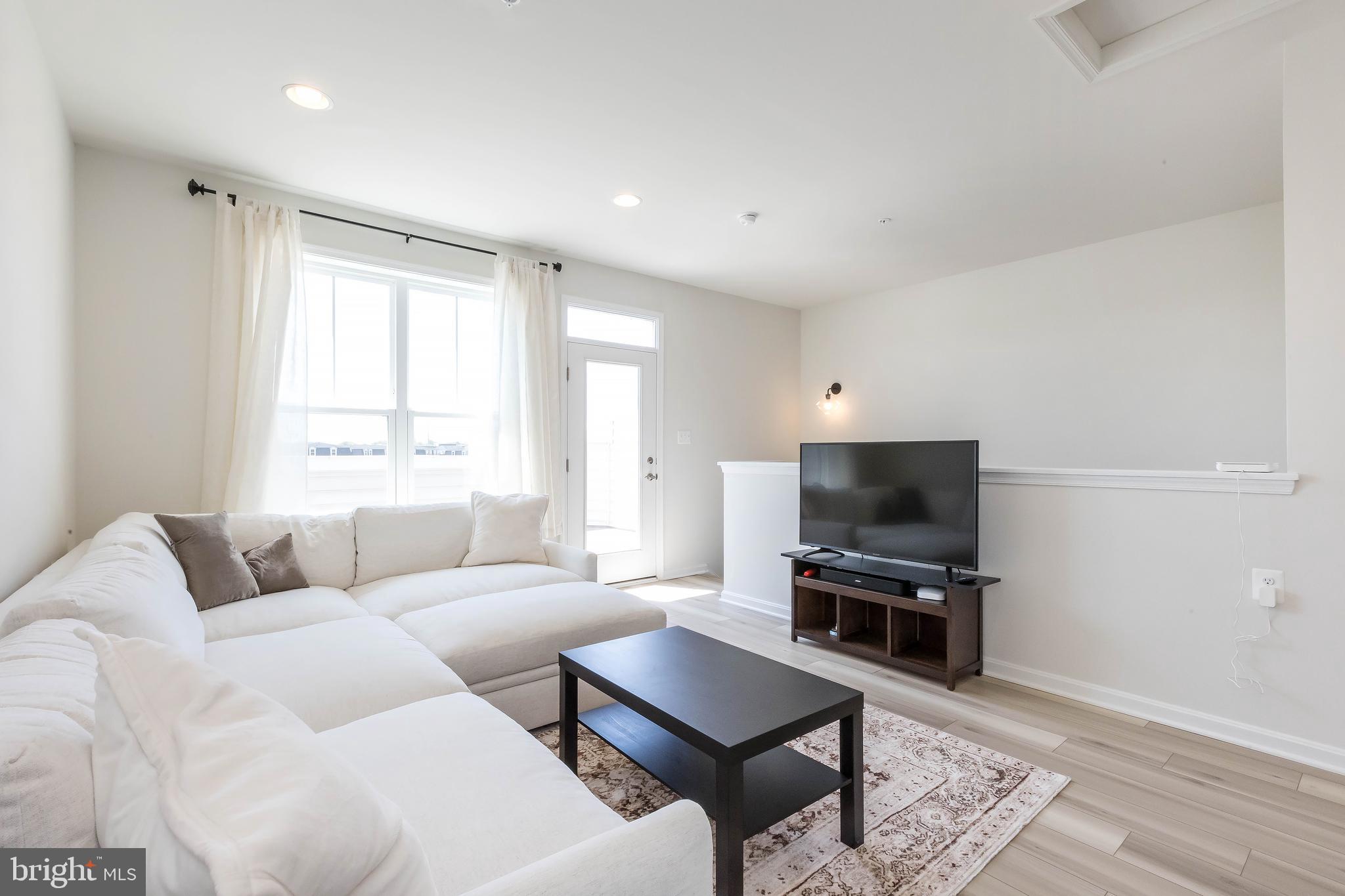 1096 Holden Road Frederick, MD 21701 - Photo 35 of 51 a living room with furniture a flat screen tv and a window