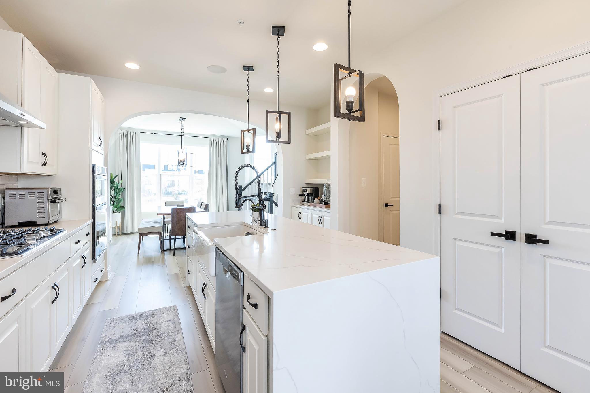 1096 Holden Road Frederick, MD 21701 - Photo 8 of 51 a large kitchen with stainless steel appliances a stove a sink a refrigerator and a view of living room