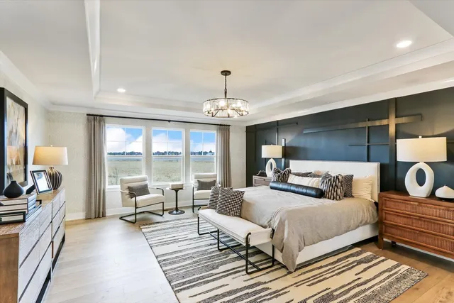 a bedroom with furniture and a large window