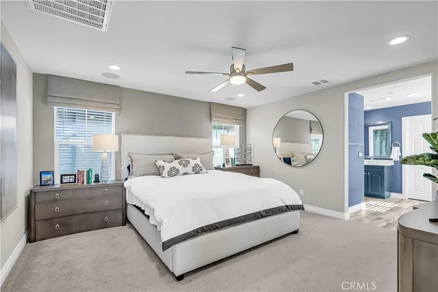 a bedroom with a large bed and a chandelier