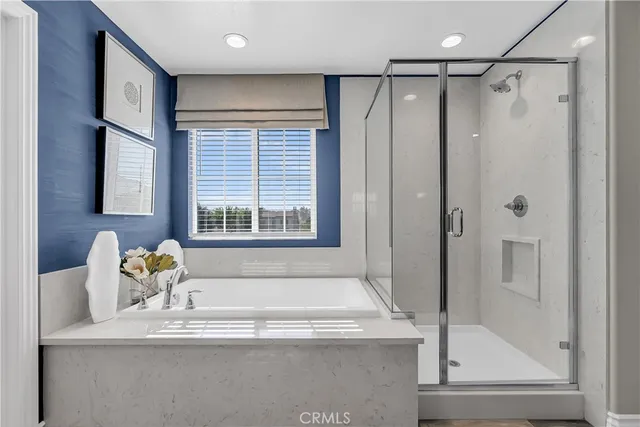 a bathroom with a tub and a window